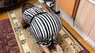On the floor, a housewife is on her knees and feels a dick in her ass when she has anal sex