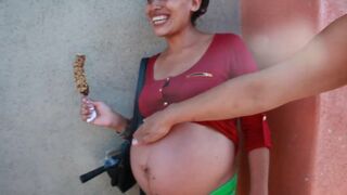 pregnant street-Big belly eating a chocolate covered banana